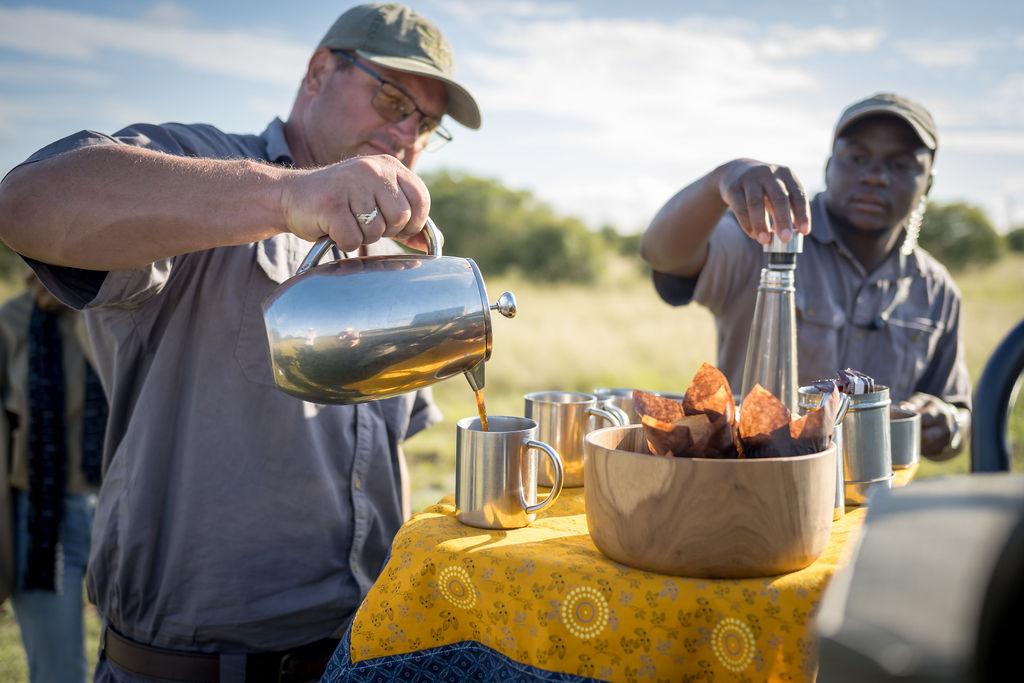 Rangers pouring coffee for guests on safari, Thornybush Game Reserve, Greater Kruger, South Africa